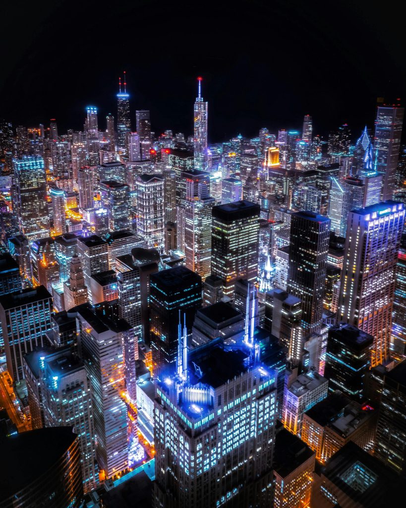 Stunning aerial view of Chicago's illuminated skyline with skyscrapers lit up at night.